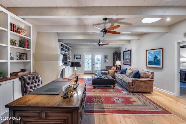 living room with light wood-type flooring, beamed ceiling, a ceiling fan, baseboards, and an office area