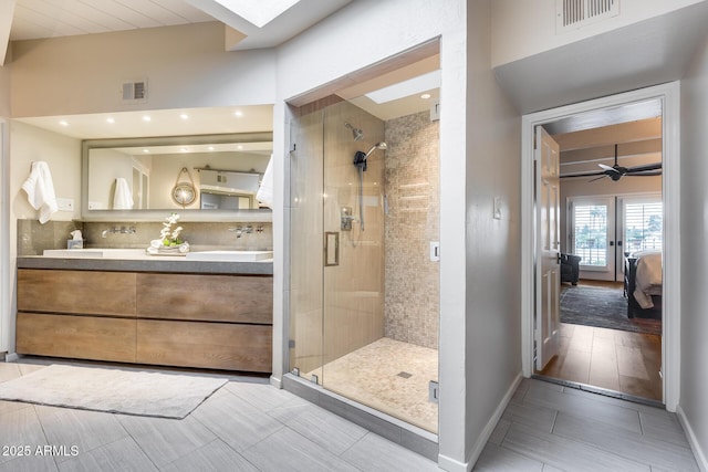 bathroom with a stall shower, ensuite bathroom, double vanity, decorative backsplash, and recessed lighting
