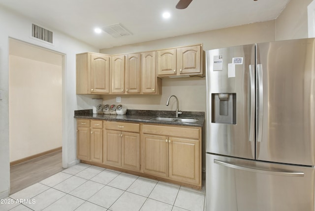 kitchen with sink, ceiling fan, stainless steel refrigerator with ice dispenser, light tile patterned flooring, and light brown cabinetry