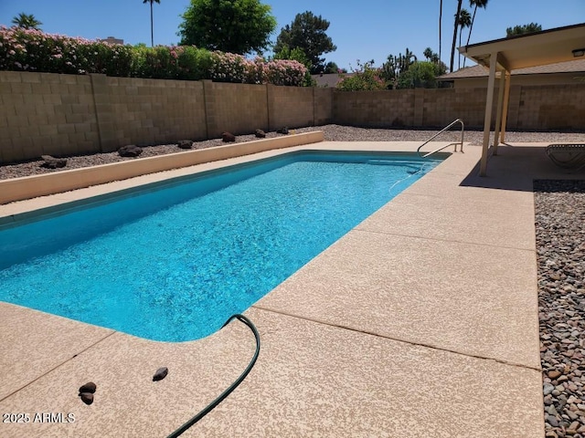 view of pool featuring a patio area and a fenced backyard