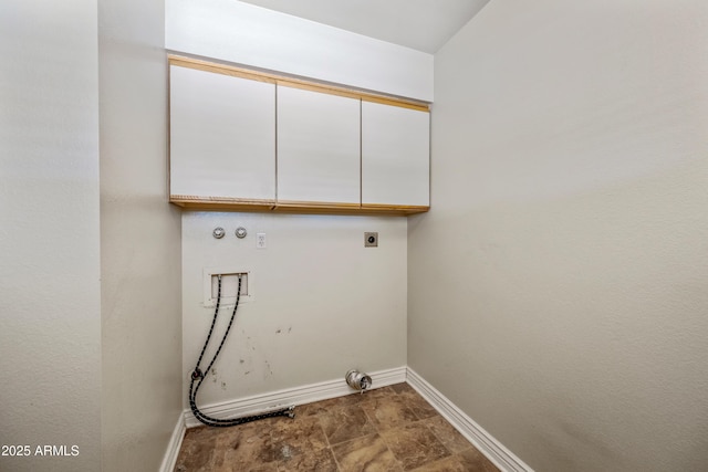 clothes washing area with cabinet space, hookup for a gas dryer, baseboards, electric dryer hookup, and washer hookup