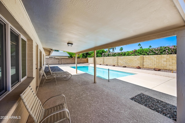view of swimming pool featuring a patio and a fenced backyard