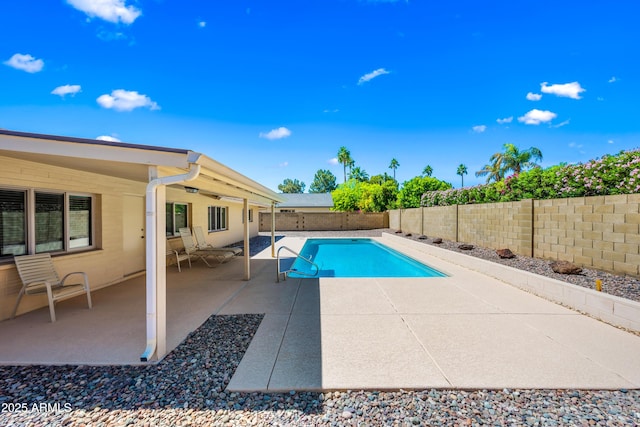 view of pool with a patio and a fenced backyard