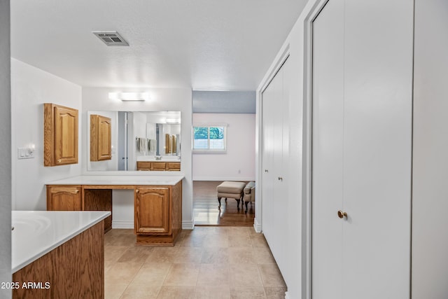 bathroom featuring vanity, baseboards, and tile patterned floors