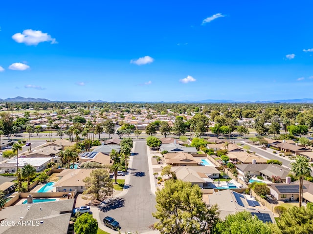 aerial perspective of suburban area with a mountainous background and a pool