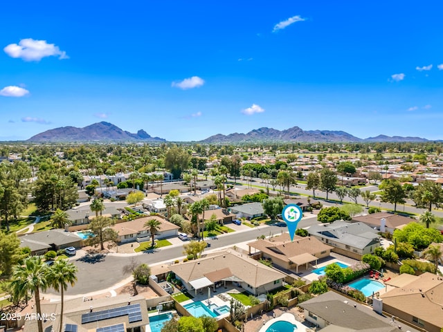 aerial view of residential area featuring a pool and mountains
