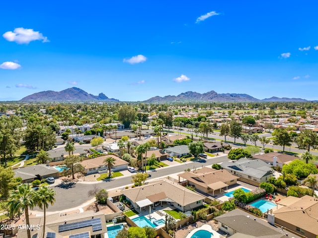 aerial perspective of suburban area with a pool and mountains