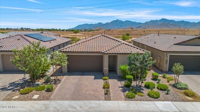 view of front facade featuring a garage and a mountain view