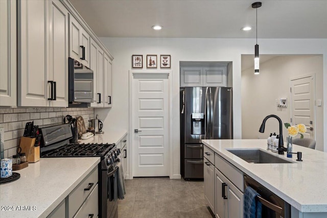 kitchen featuring light tile patterned floors, hanging light fixtures, stainless steel fridge with ice dispenser, sink, and range with gas cooktop