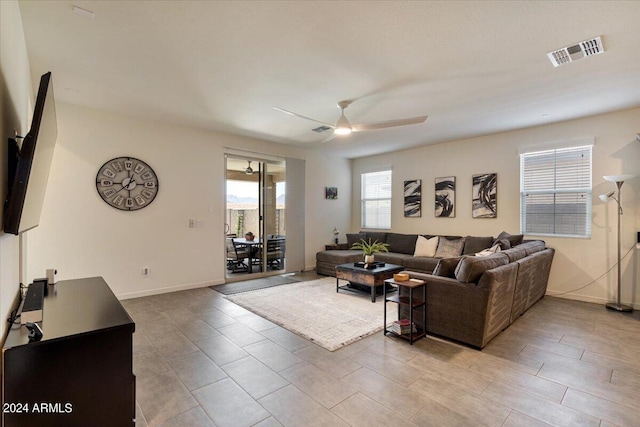 living room with light tile patterned flooring and ceiling fan