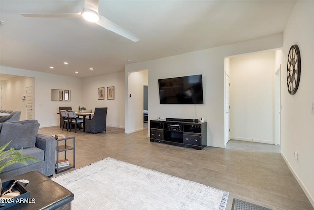 living room featuring ceiling fan and light tile patterned flooring