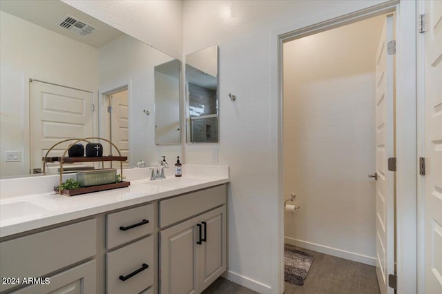 bathroom featuring tile patterned floors and dual bowl vanity