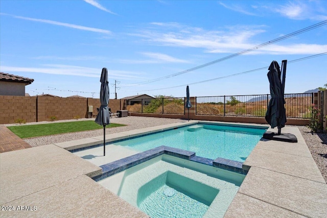 view of pool with an in ground hot tub