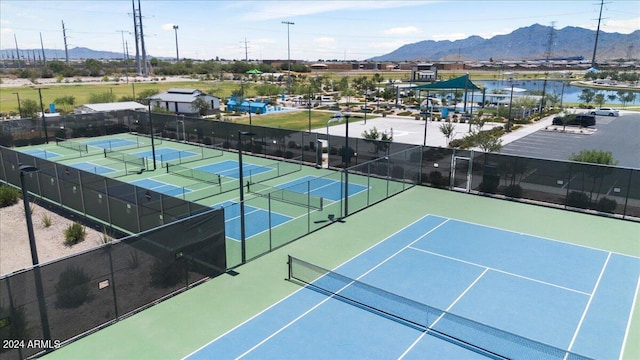 view of tennis court with a mountain view