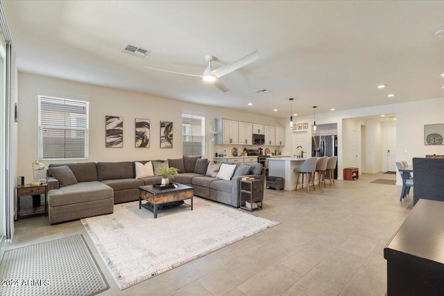 living room featuring ceiling fan and light tile patterned flooring