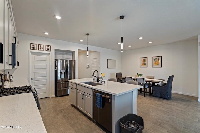 kitchen featuring sink, a kitchen island with sink, dishwashing machine, and gray cabinets