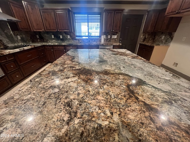 kitchen with black electric stovetop, dark stone countertops, dark brown cabinetry, and exhaust hood