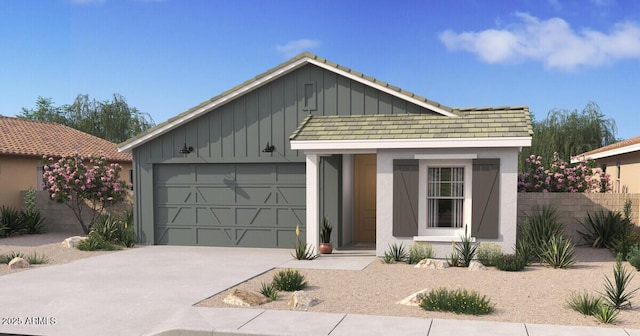 view of front of home with board and batten siding, concrete driveway, an attached garage, and fence