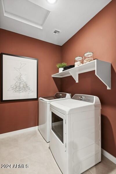 laundry area featuring light tile patterned floors, laundry area, attic access, and separate washer and dryer