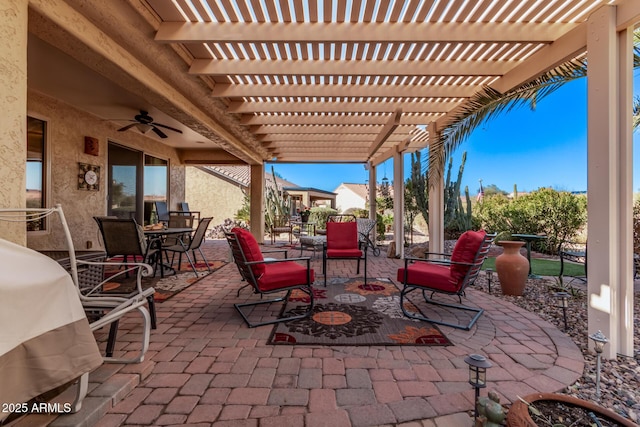 view of patio / terrace with ceiling fan and a pergola