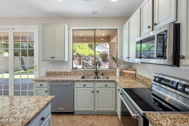 7758 E Nestling Way, Scottsdale, AZ 85255 - kitchen with appliances with stainless steel finishes, a sink, light stone countertops, and white cabinetry