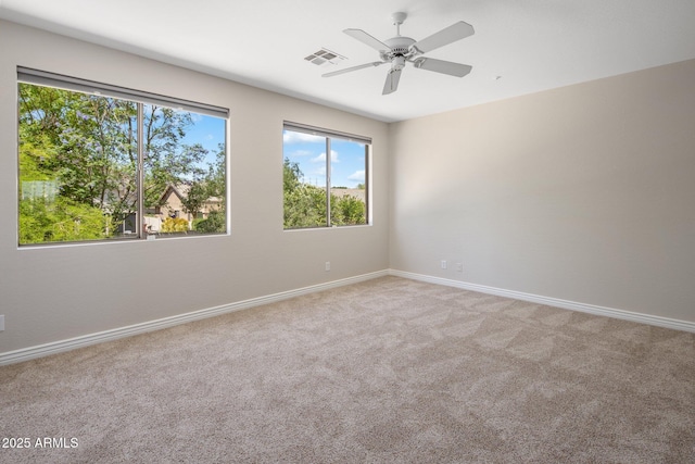 7758 E Nestling Way, Scottsdale, AZ 85255 - unfurnished room featuring plenty of natural light, carpet, baseboards, and a ceiling fan