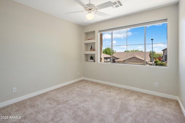 7758 E Nestling Way, Scottsdale, AZ 85255 - carpeted spare room with baseboards, ceiling fan, and built in shelves