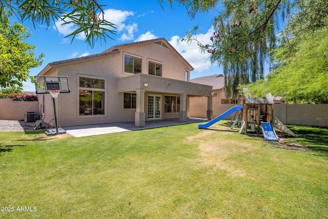 7758 E Nestling Way, Scottsdale, AZ 85255 - back of property with stucco siding, a playground, a patio area, french doors, and central AC