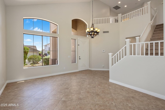 7758 E Nestling Way, Scottsdale, AZ 85255 - tiled entryway with a chandelier, stairs, high vaulted ceiling, baseboards, and recessed lighting