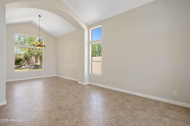 7758 E Nestling Way, Scottsdale, AZ 85255 - unfurnished room with arched walkways, a chandelier, lofted ceiling, light tile patterned flooring, and baseboards