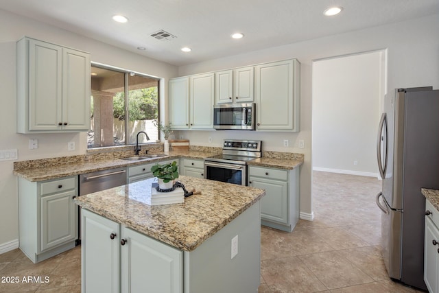 7758 E Nestling Way, Scottsdale, AZ 85255 - kitchen featuring appliances with stainless steel finishes, a sink, a kitchen island, baseboards, and recessed lighting