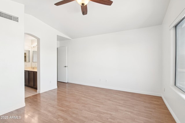 spare room with ceiling fan, lofted ceiling, and light hardwood / wood-style flooring