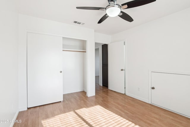 unfurnished bedroom featuring a closet, ceiling fan, and light hardwood / wood-style flooring