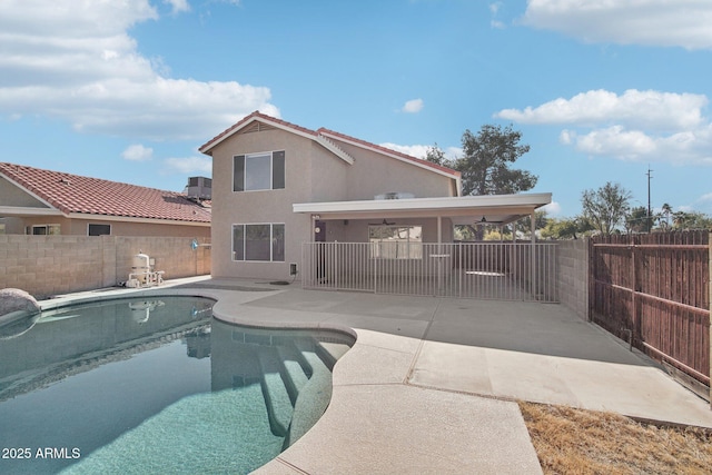 view of swimming pool with ceiling fan and a patio