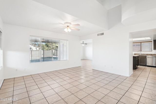 spare room with light tile patterned floors and ceiling fan