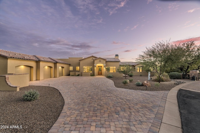 mediterranean / spanish house with a garage