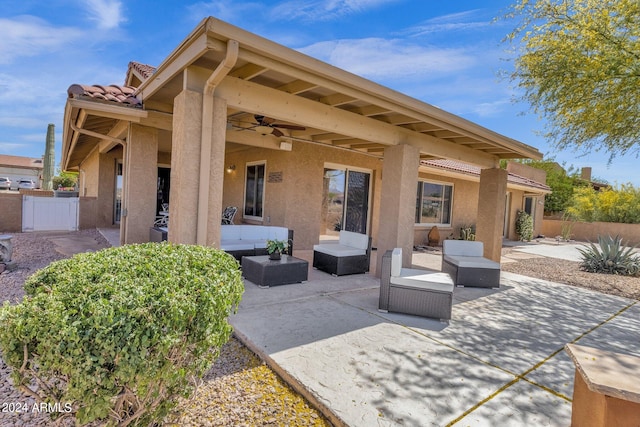 view of patio featuring a ceiling fan, outdoor lounge area, and fence