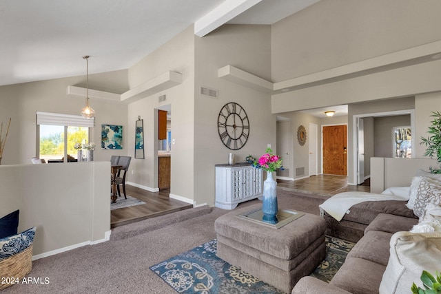 carpeted living room featuring high vaulted ceiling, baseboards, and visible vents