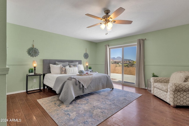 bedroom with dark wood-type flooring, ceiling fan, and access to outside