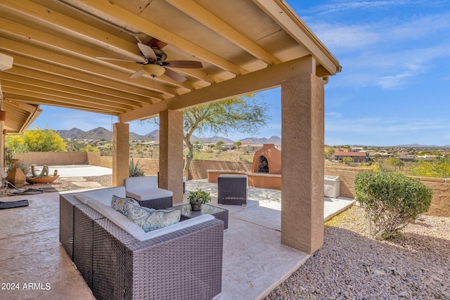 view of patio / terrace with ceiling fan, a fenced backyard, a mountain view, and outdoor lounge area