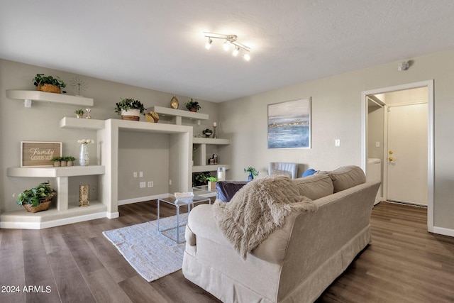 living area with baseboards and wood finished floors