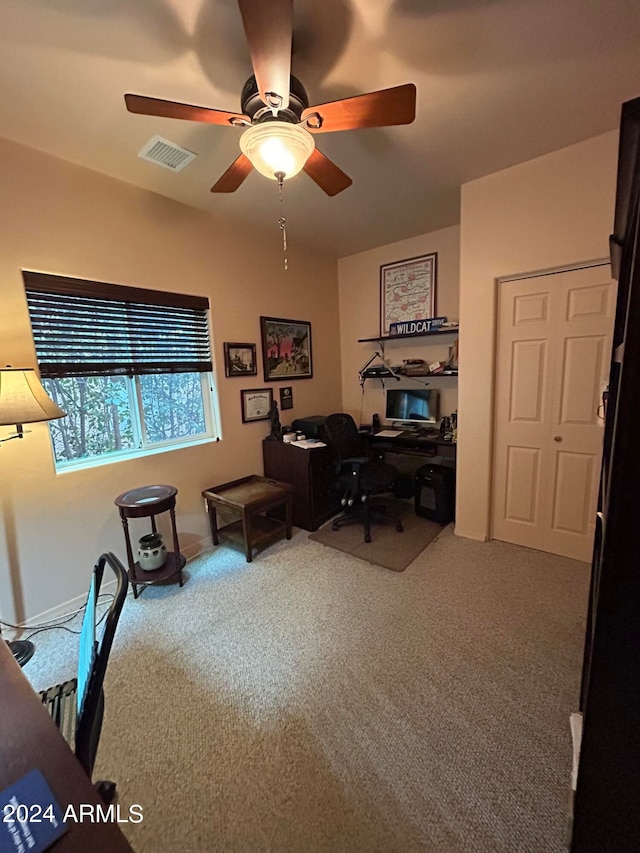 carpeted office space with ceiling fan