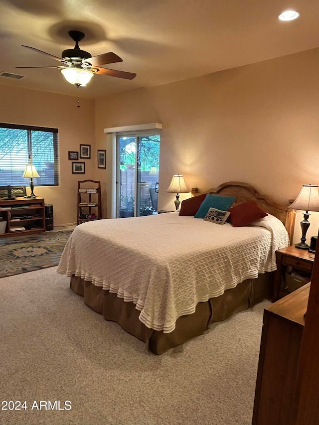 bedroom with ceiling fan, carpet floors, and multiple windows