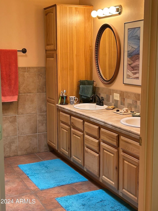 bathroom with vanity and tile walls