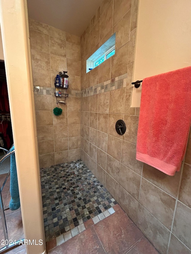 bathroom with a tile shower