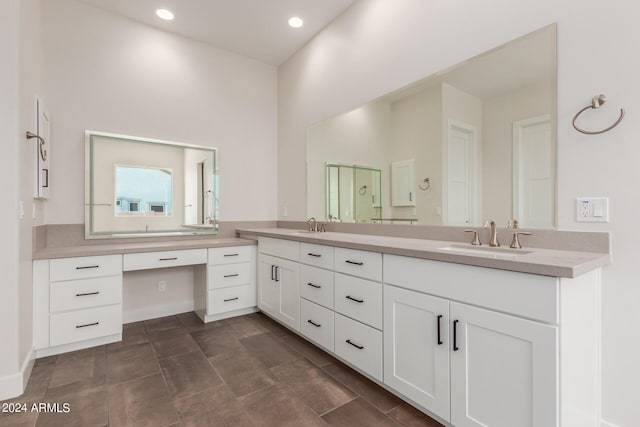 bathroom featuring double vanity, a sink, and recessed lighting