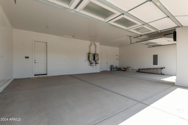 garage featuring water heater and electric panel