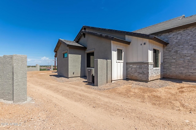 view of side of property with stone siding and board and batten siding