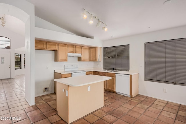 kitchen with white appliances, a sink, vaulted ceiling, under cabinet range hood, and a center island