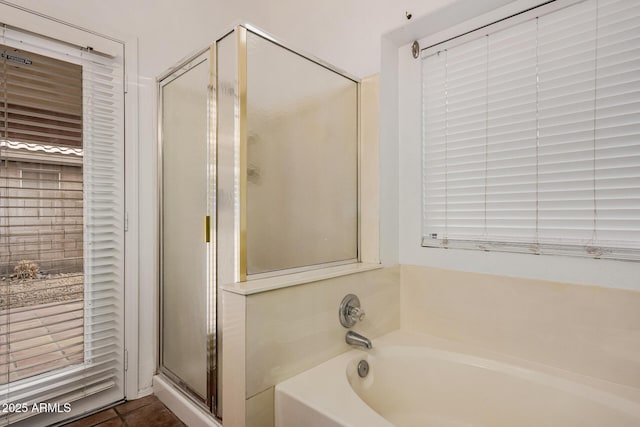 full bathroom with a bath, tile patterned flooring, and a stall shower